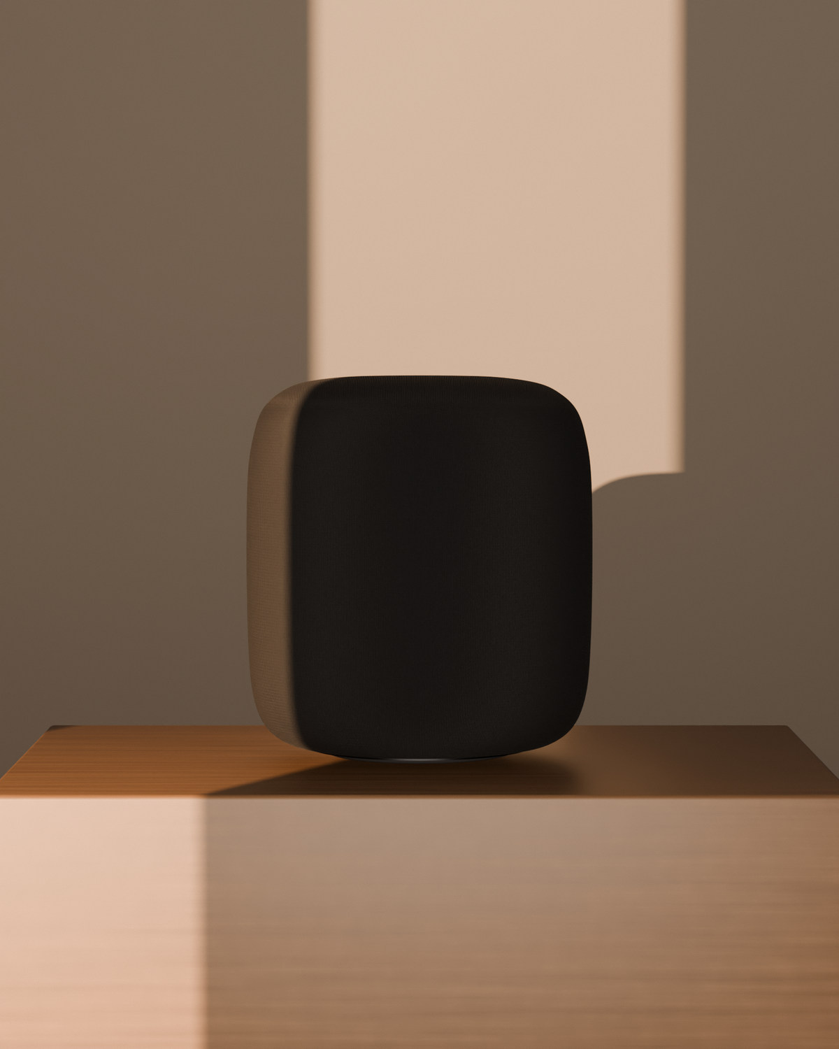 aaro one in Graphite on a walnut block, a blade of evening light on the wall behind it